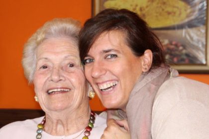 Woman and Grandma smiling at the camera.